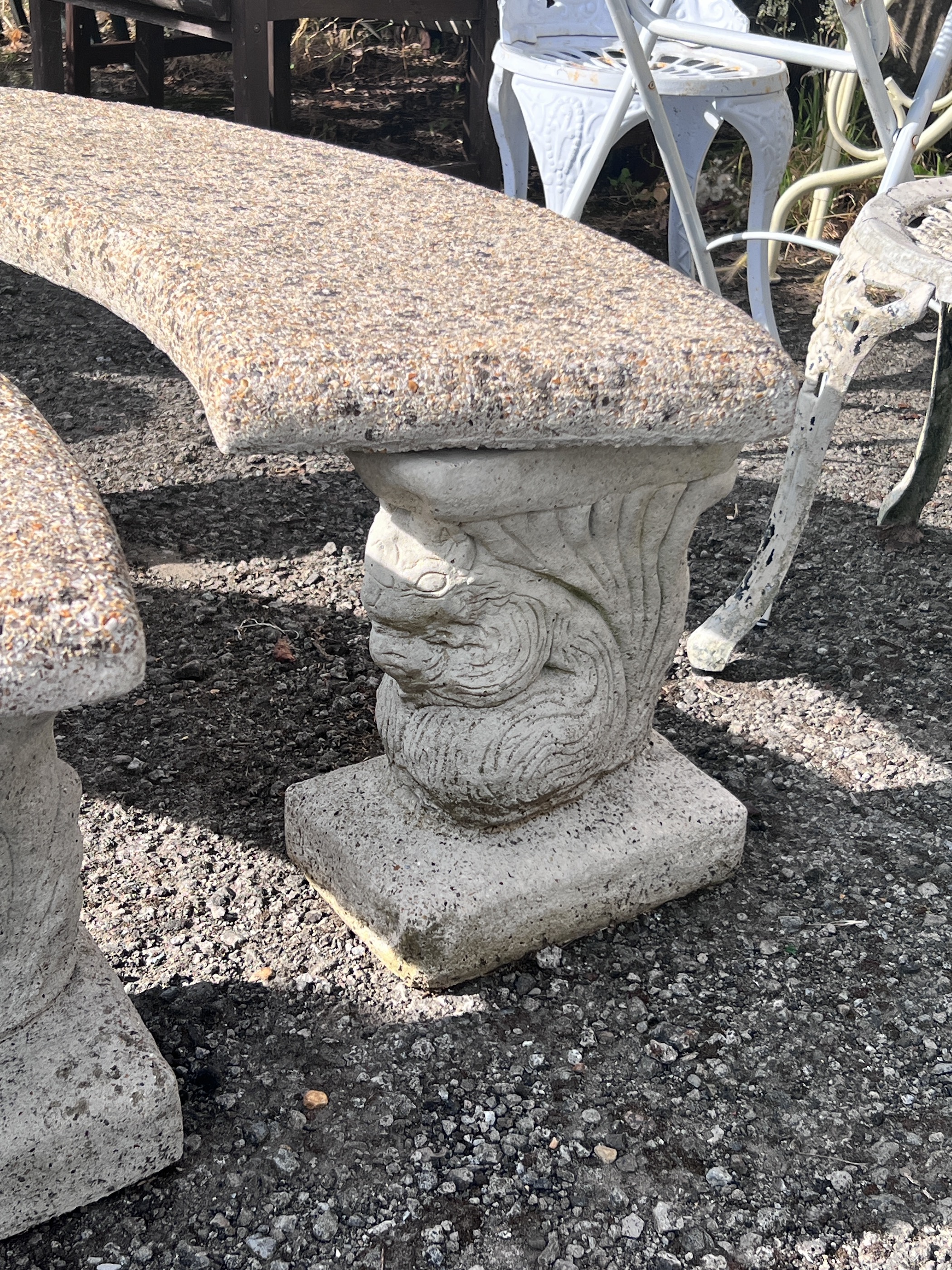 A pair of curved reconstituted stone garden benches, width 122cm, height 45cm